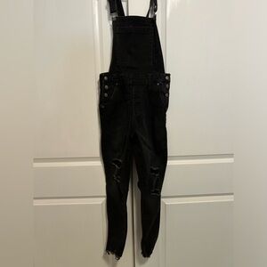 Ripped skinny jean overalls.